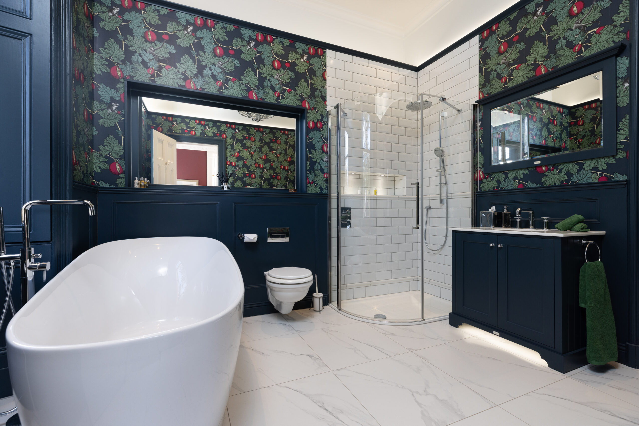 A traditional bathroom renovation featuring a bath and shower area in Edinburgh