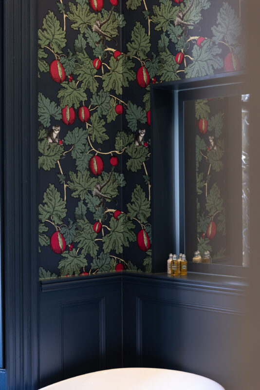 A nicely installed wall panel and wallpaper to create a traditional bathroom style.