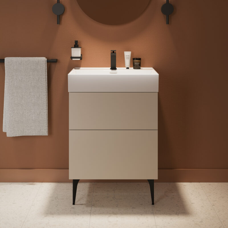 A free-standing vanity unit with double drawers and a mirror above it. The legs of the vanity unit and the bathroom accessories come in a matte black finish.