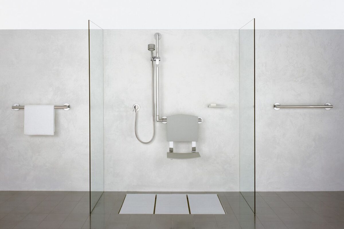A spacious walk-in shower for an accessible bathroom, featuring anti-slip flooring and grab bars for ease of movement.