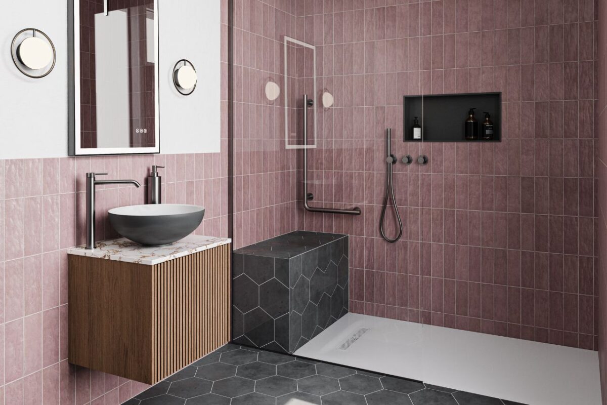 An accessible bathroom featuring a wall-mounted vanity unit with a basin. A large wall in the shower has grab bars and a fitted bench.