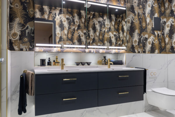 Elegant master ensuite bathroom with floating vanity, dual sinks, gold fixtures, and leopardo black and gold wallpaper.