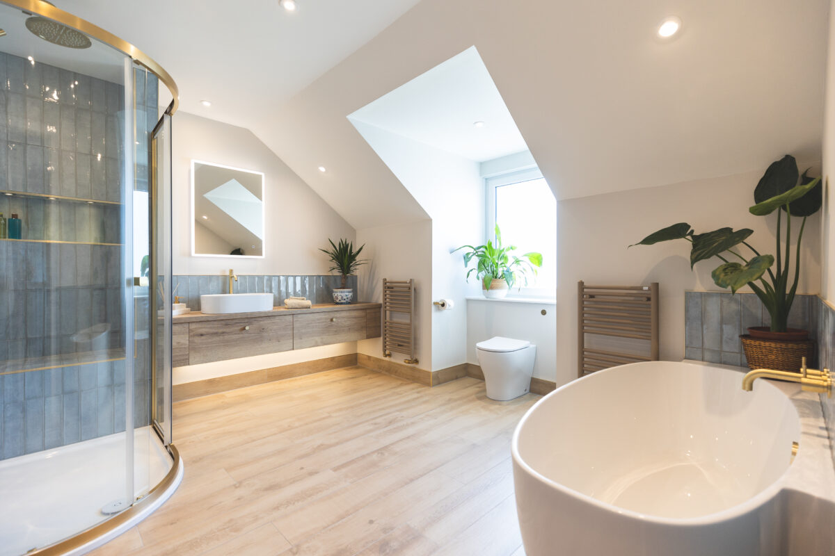The Bathroom Company In Broughty Ferry. This image features a spacious bathroom with both a shower area and a bath area.