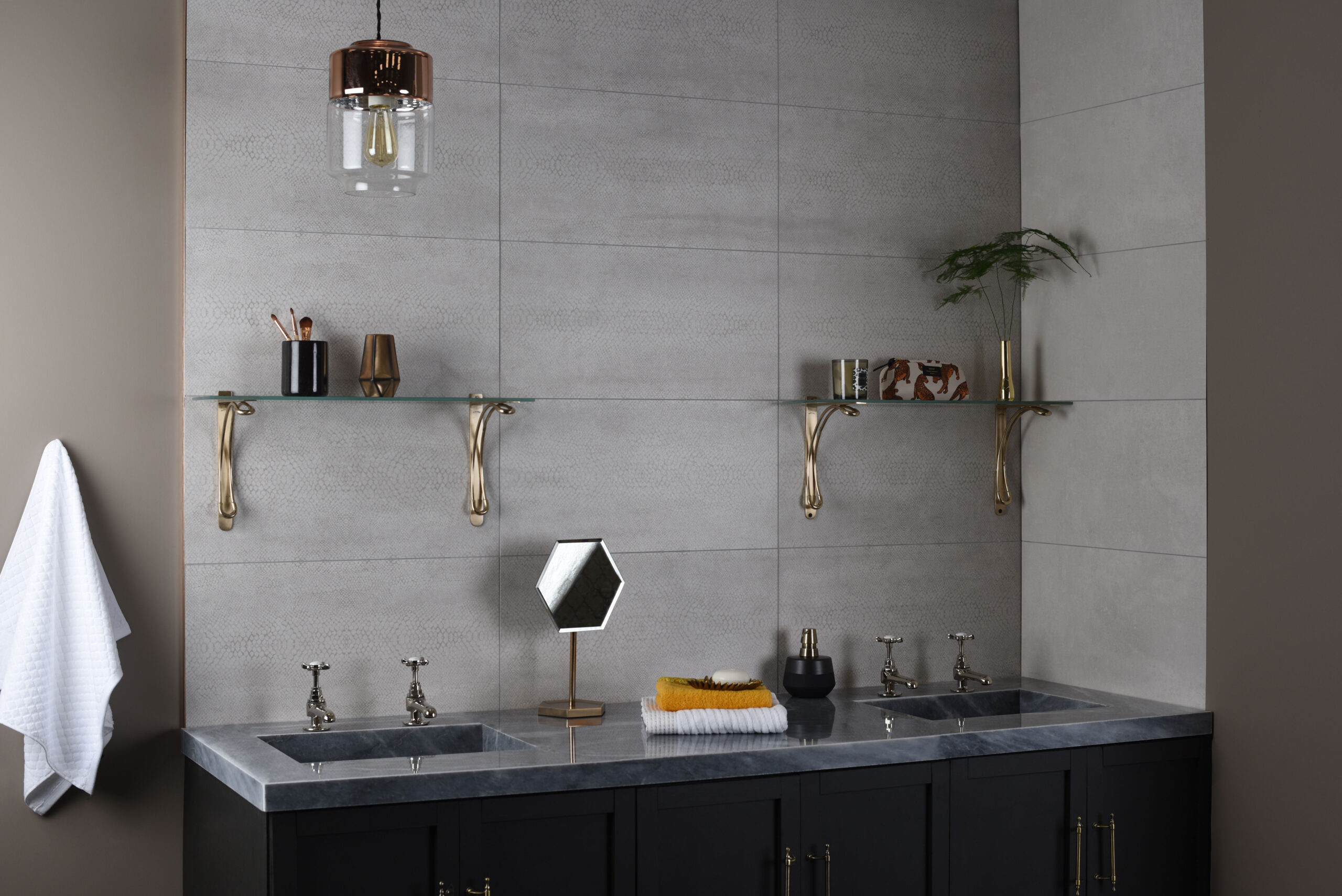 A traditional style bathroom with glass wall shelves for serving and storage, and a large vanity unit with dual basins.