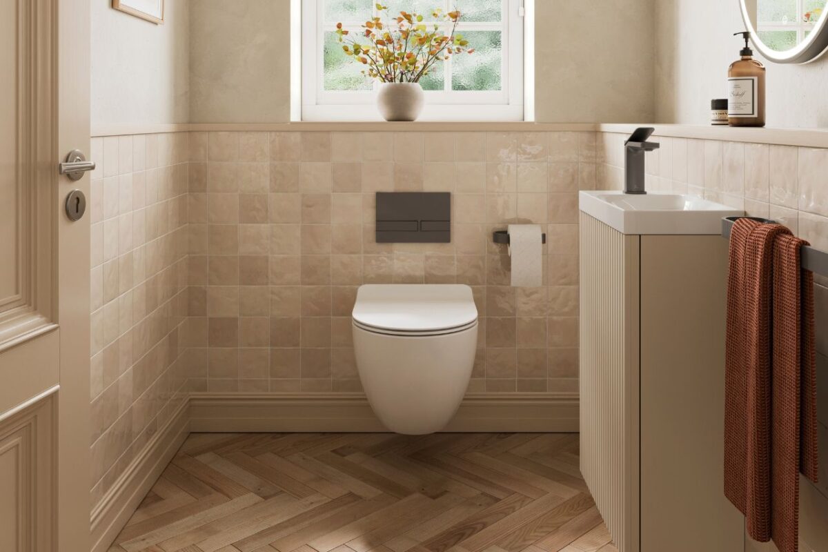 Stylish cloakroom featuring herringbone flooring in warm natural oak tones, adding texture and movement to the compact space. The space also includes a vanity unit and a wall-hung WC. oak tones, addi