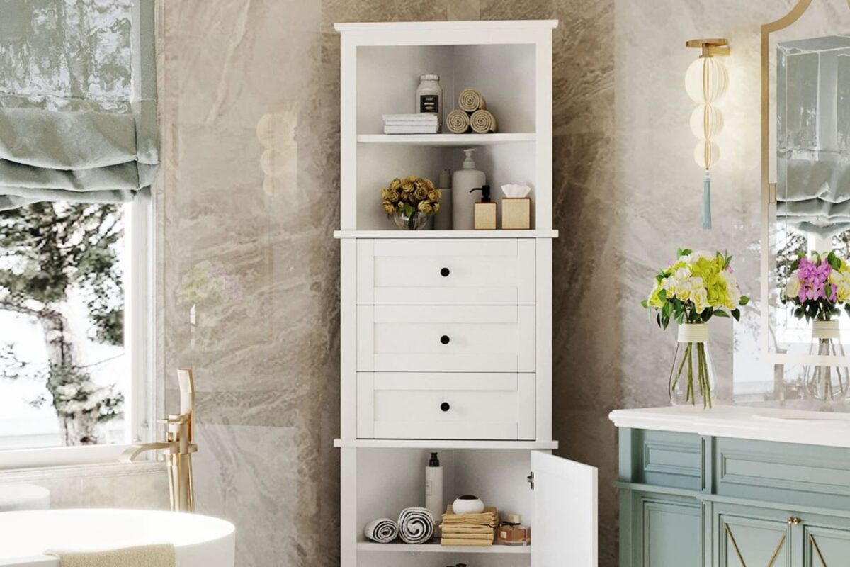 A modern bathroom with a tall white storage corner cabinet with open shelves and drawers, next to a freestanding bath.