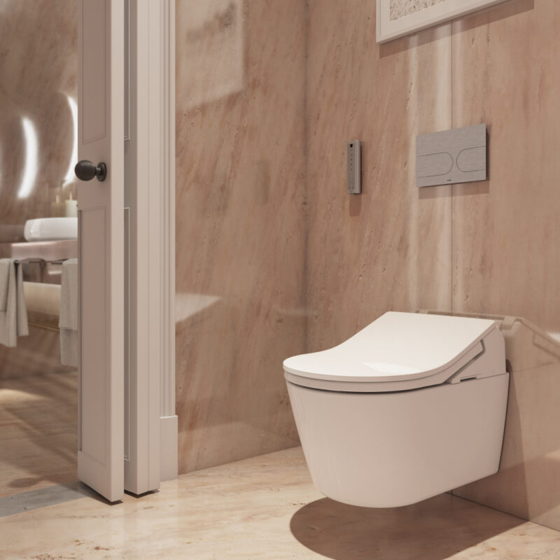 The WASHLET toilet from TOTO is wall-mounted in a contemporary bathroom. Above it is the flush plate and the remote control for easy use.